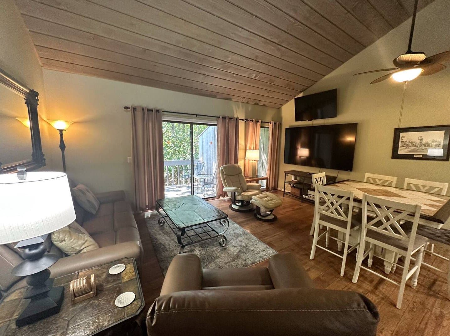 Living room with leather seating and sliding door to deck